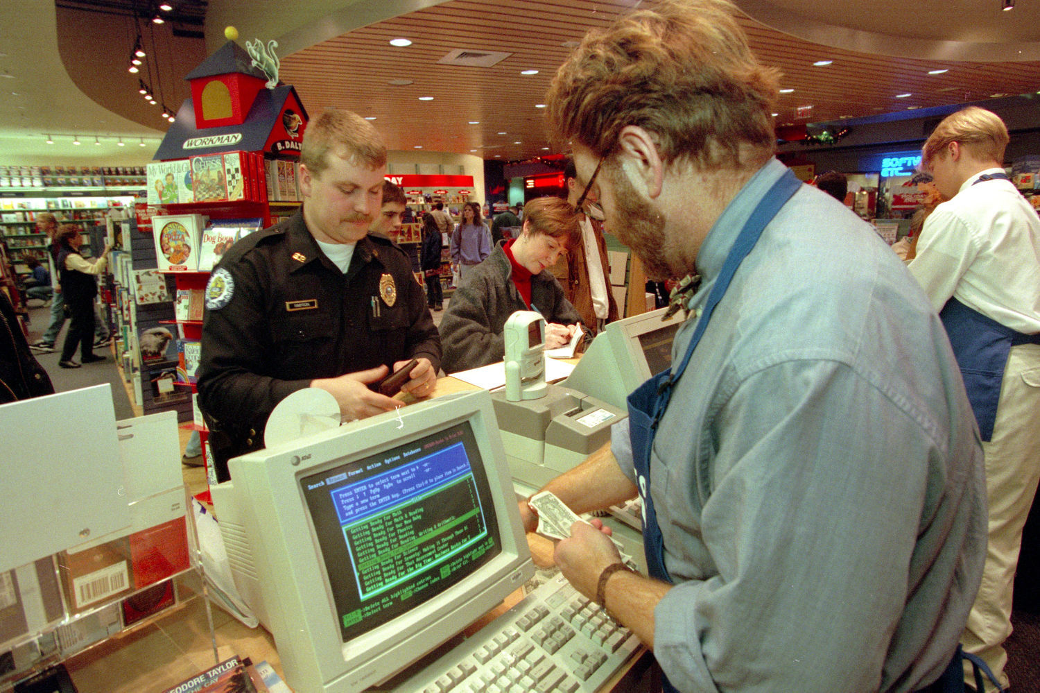Police officer buying gifts for children at Rimrock Mall, 1996